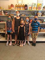posed kids in food pantry